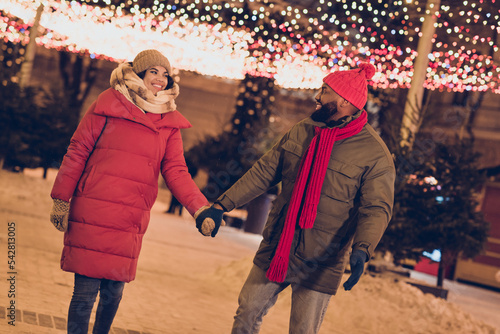 Photo of funny charming boyfriend girlfriend dressed winter season outfits walking noel x-mas fair outdoors urban city street