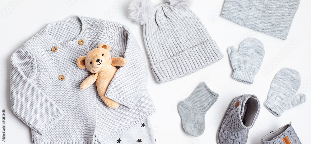 Collection of cute organic gender neutral baby clothes and booties