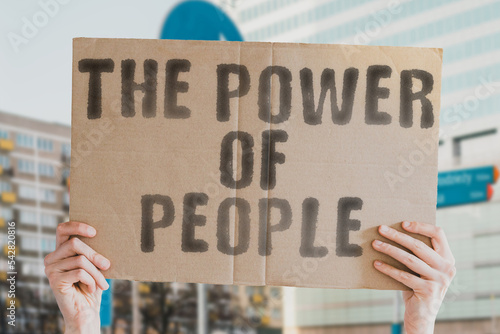 Wallpaper Mural The phrase " The power of people " is on a banner in men's hands with blurred background. Powerful. Positive. Proud. Pride. Population. Strike. Triumph. Motivated. Crowd. Fight. Social. Anger Torontodigital.ca