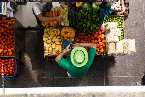 Foto man with green shirt buying vegetables in brazil