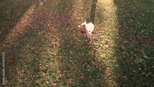 High angle of a man Raking leaves in a backyard. photo