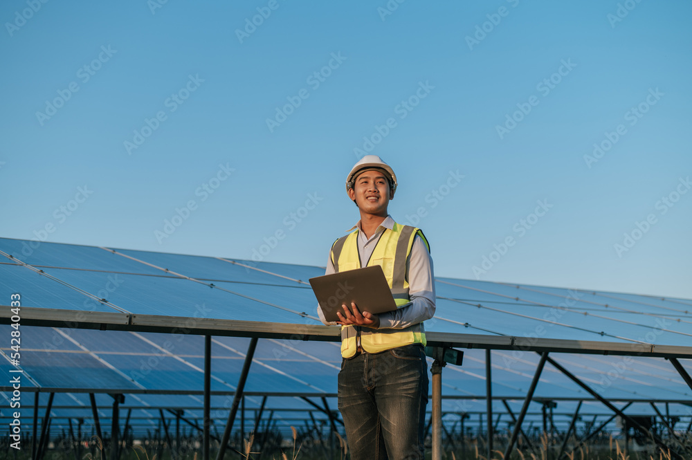 Young Asian technician man checking operation photovoltaic solar panel