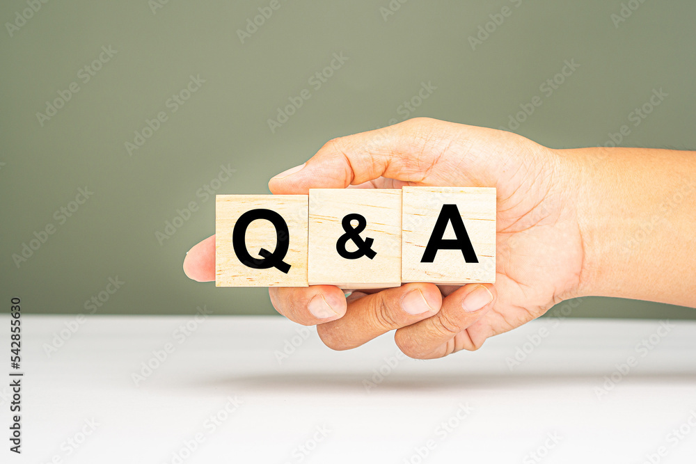 Question and Answer concept. Hand holding of wooden cubes with words Q and A Question and Answer concept. Hand holding of wooden cubes with words Q and A