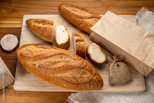 Baked baguette and multigrain loaf bread in Paper bag ready to serve.