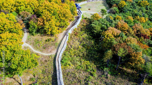 Aerial view of Gomosan fortress wall and gate house in South Korea on sunny fall day.