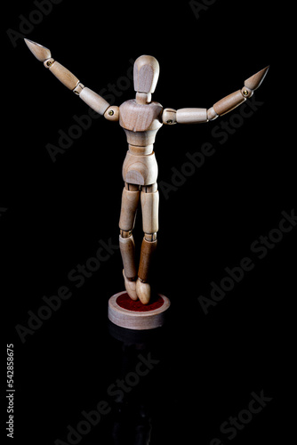 Image of wooden manikin on black background poses different posing