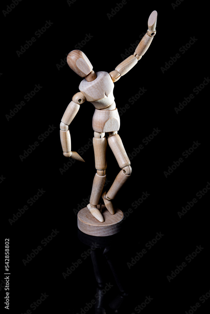 Image of wooden manikin on black background poses different posing Image of wooden manikin on black background poses different posing