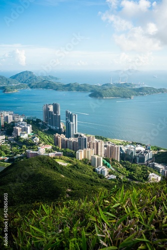 Vertical shot of Hong Kong coastal city with boats on the water photo