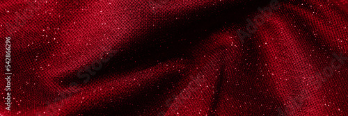 Abstract red fabric with shiny particules background for banner. photo