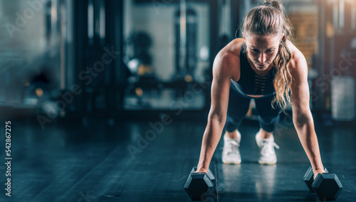 Woman Doing Push-ups with dumbbells