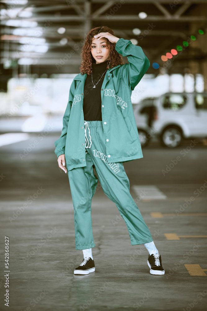 Urban, fashion and girl portrait at parking lot in New York with edgy  athleisure style. Gen Z, trendy and statement clothes of young city woman  with assertive, confident and cool pose. Stock