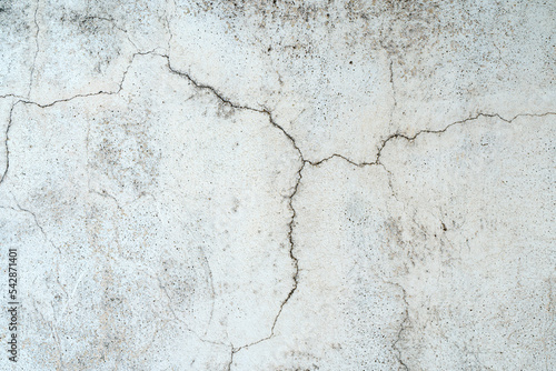 Old concrete stone wall covered with cracked plaster and dirty grunge textured surface. © uladzimirzuyeu