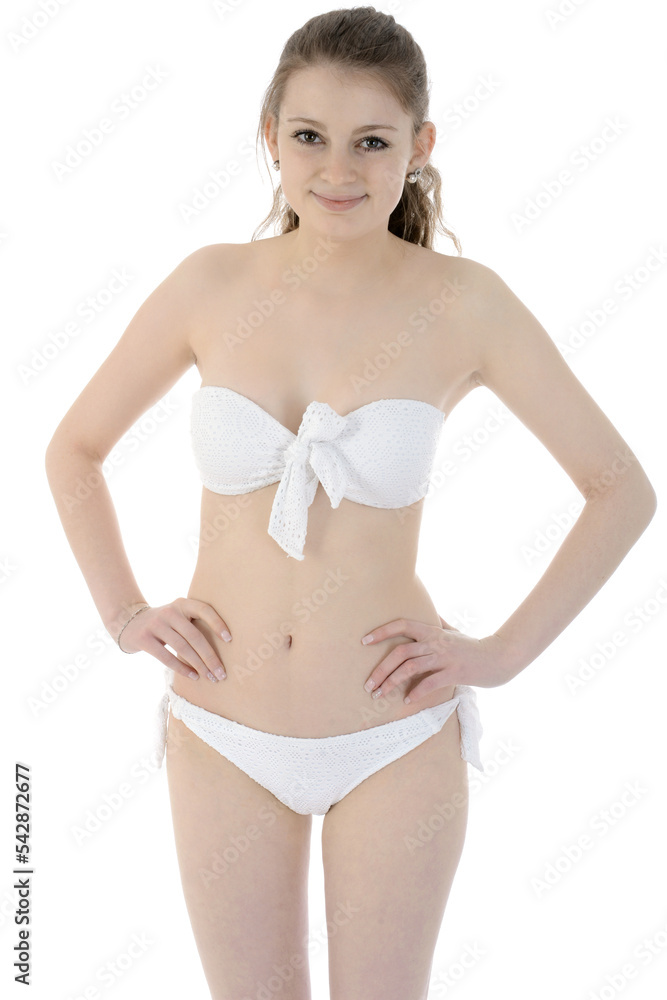 Happy smiling teenage girl wears white bikini bandeau isolated on white in studio