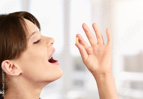 Medical supplement, woman holding pill