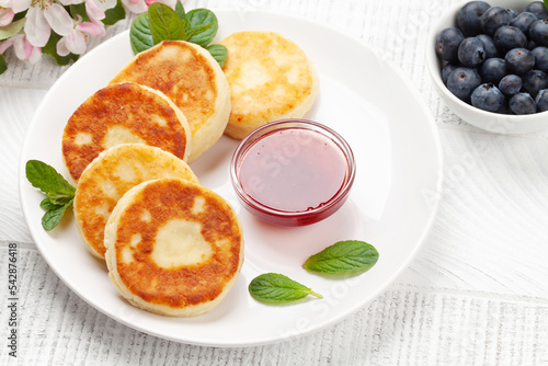 Cottage pancakes with jam and berries photo