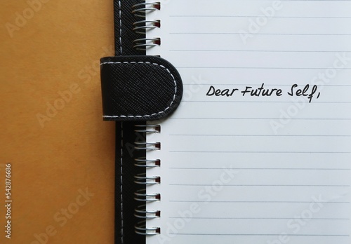 Notebook with handwritten text DEAR FUTURE SELF, a letter to convey message to future you. specific goals to achieve, follow up on bucket list items or declare important affirmation