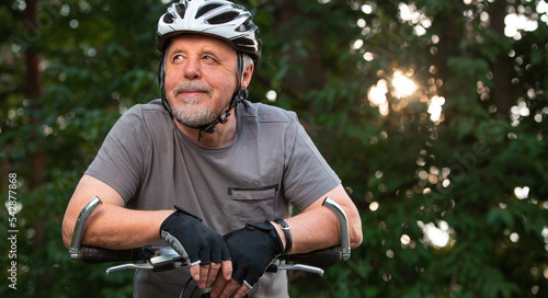 Portrait of active senior man with his bike in outside, healthy lifestyle sport concept