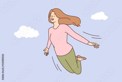 Smiling woman flying in sky