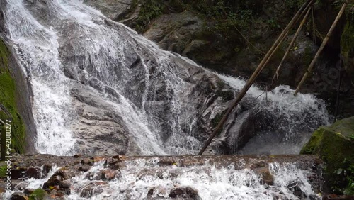 Stunning waterfall cascades in jugnle, medium locked off shot photo