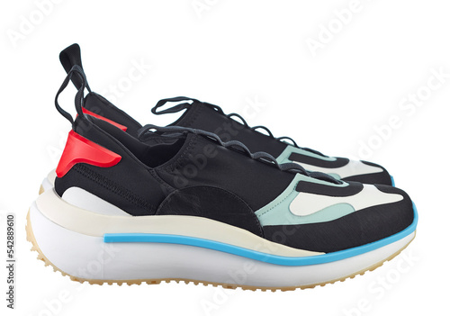 Side view fashionable sneakers made of a combined color texture, on a bright colored sole, with lacing, isolated on a white background.