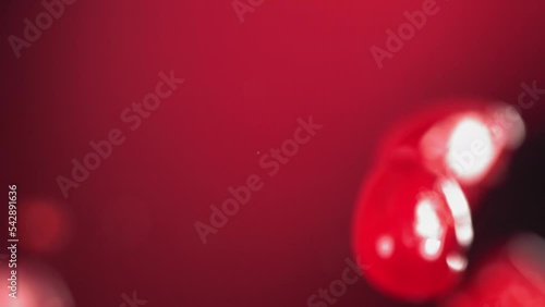 Super Slow Motion Shot of Fresh Pomegranate Seeds and Water Side Collision on Red Background photo