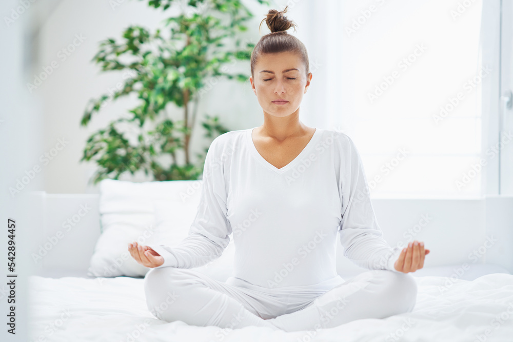 Nice female in bed relaxing or doing yoga Nice female in bed relaxing or doing yoga