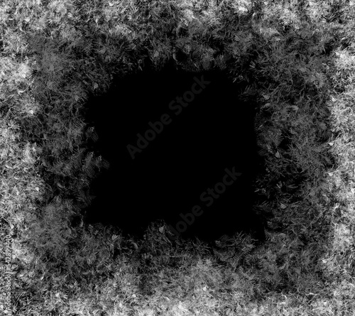 A frame of a frosty pattern  on a black background. A frame with an abstract ice structure allows you to apply or add a frost effect. Frost on the glass, freezing effect