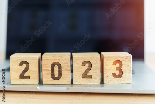 2023 Year block against computer laptop background. Goal, Target, Resolution, strategy, plan, finance, budget, motivation, and New Year start concepts