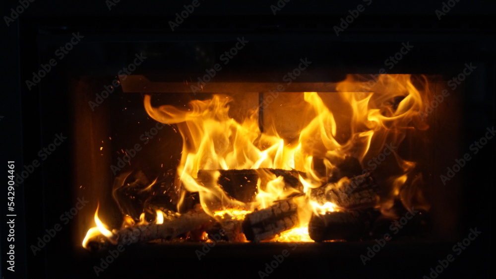 Fire in the fireplace. Winter night.