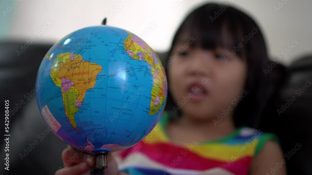 Close up globe explored by little girl. Preschool activity concept Close up globe explored by little girl. Preschool activity concept
