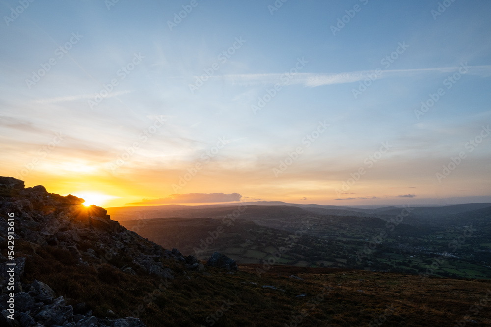A view looking west from the top of the Blorenge mountain in Abergavenny. The sun sets in the direction of the Brecon Beacons Black Mountains which are popular for hikers, walkers and ramblers
