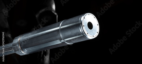 Tablou pe pânză Silencer and skull on a dark background