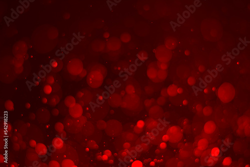 Red glitter vintage lights background. red bokeh shiny on dark background.
