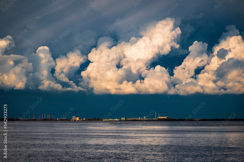 Towards the sunset. Marano lagoon late summer colors. Clouds and sun Towards the sunset. Marano lagoon late summer colors. Clouds and sun