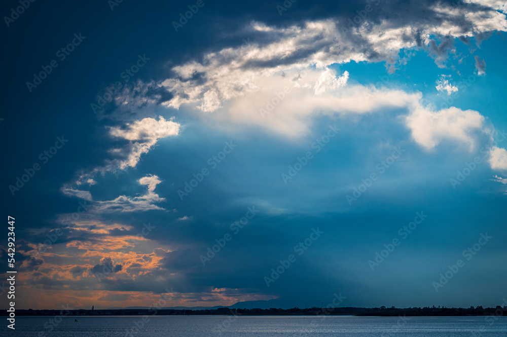 Towards the sunset. Marano lagoon late summer colors. Clouds and sun