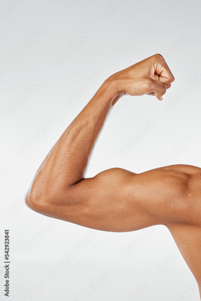 Strong man, bodybuilder and flexing arm on studio background for