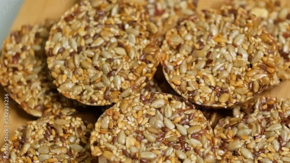Overhead view of cookies rotating. Cereal cookies close-up. Healthy snack flax seed, pumpkin, sunflower, sesame. Diet crispy crackers. Top view Overhead view of cookies rotating. Cereal cookies close-up. Healthy snack flax seed, pumpkin, sunflower, sesame. Diet crispy crackers. Top view