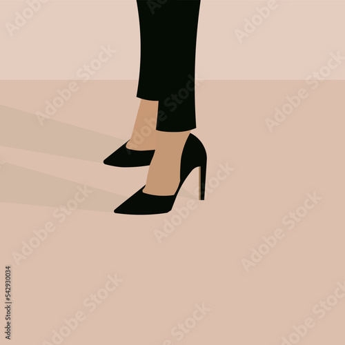 A businesswoman dressed in black pants and high-heeled shoes.
