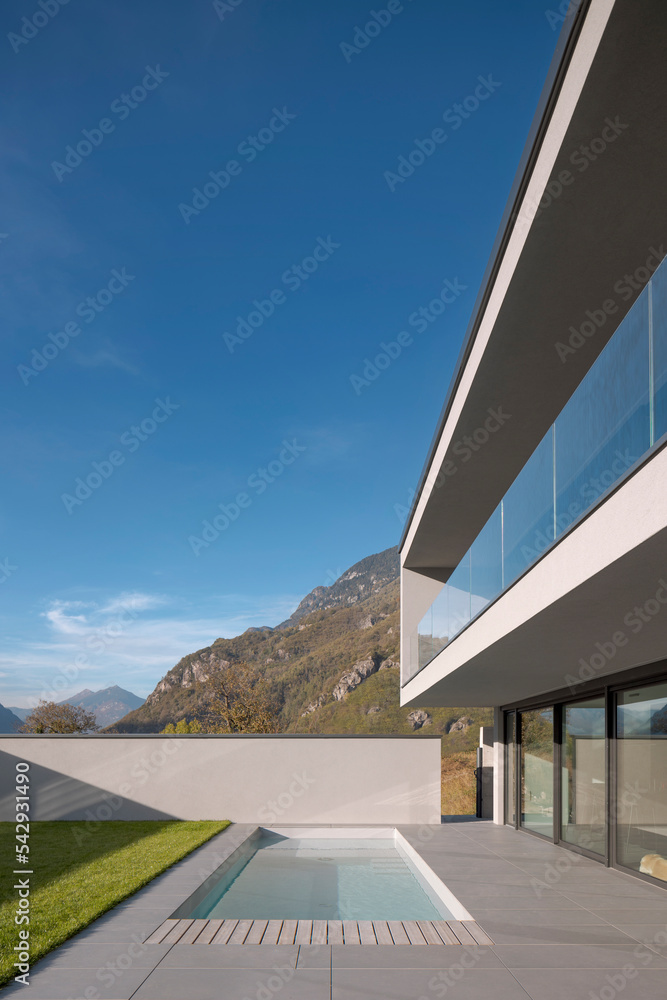 Exterior modern villa with swimming pool. The house is surrounded by ...