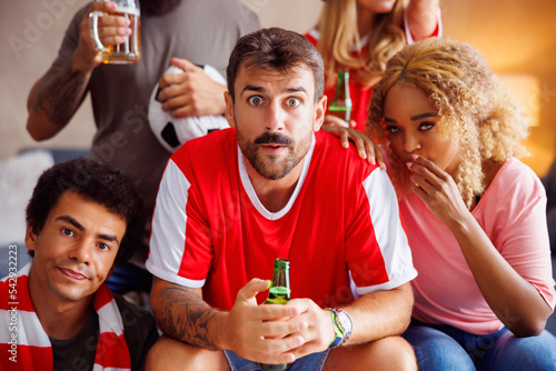 Photography Football fans watching game on TV disappointed after their team loosing