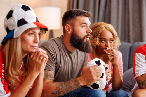 Football fans serious while watching the game on TV