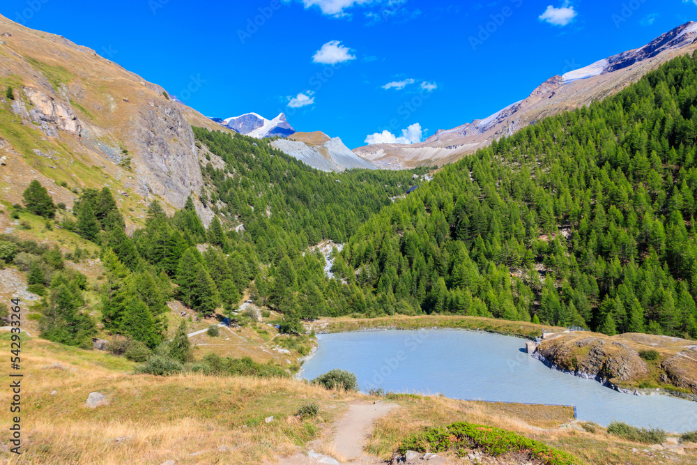 View of Moosjisee lake and the Swiss Alps at summer on the Five Lakes Trail in Zermatt, Switzerland