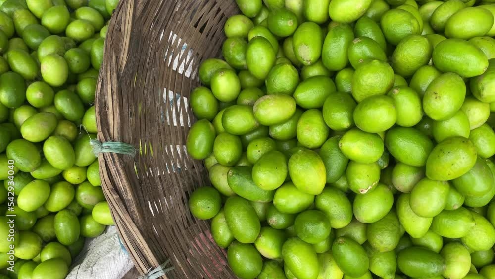 Top shot of fresh lime kept in handmade basket in local market in Bangladesh. Top shot of fresh lime kept in handmade basket in local market in Bangladesh.