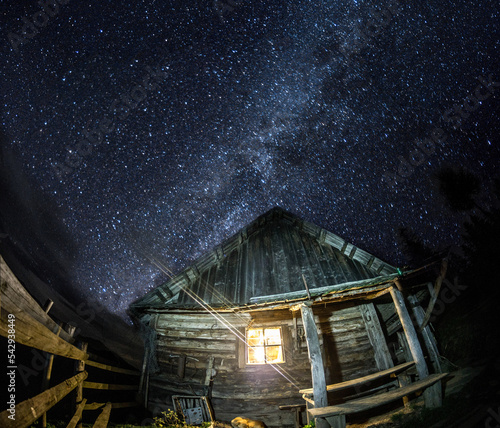 Old koliba in Carpathians at night photo