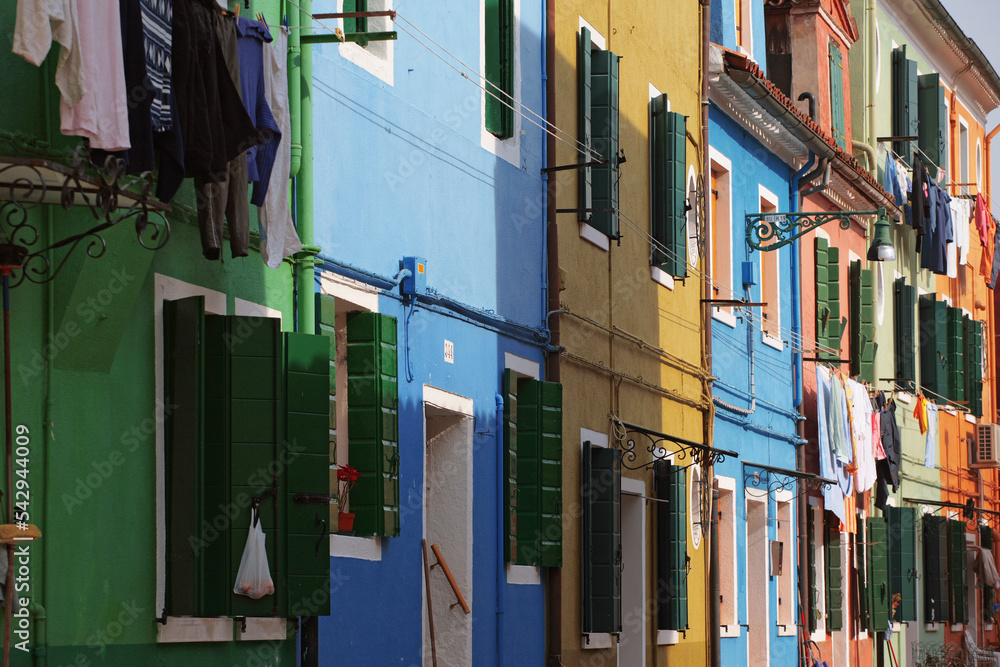 Burano, Venetian Lagoon, Italy: brightly coloured houses on Calle Broetta, with the weekly wash hanging out to dry