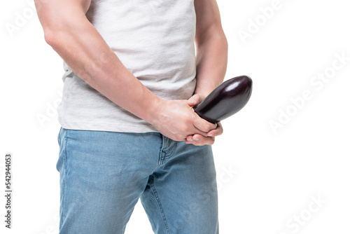 Man crop view holding eggplant at crotch level imitating erect penis isolated on white photo