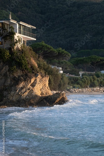 coastside villa at the beach at sunset in elba italy photo