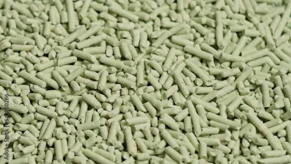 Overhead view of compacted wooden sawdust pellet rotating. natural cat