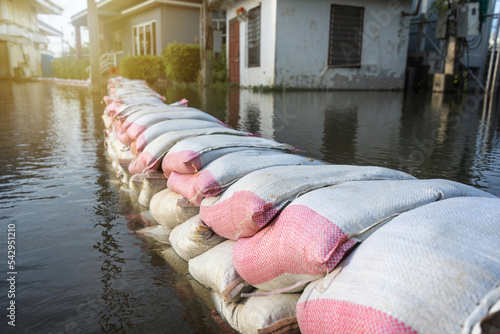 line flood barrier sandbag from the Tha Chin River that overflows in the flood season at Nakhon Chai Si District Nakhon Pathom Province of Thailand. photo