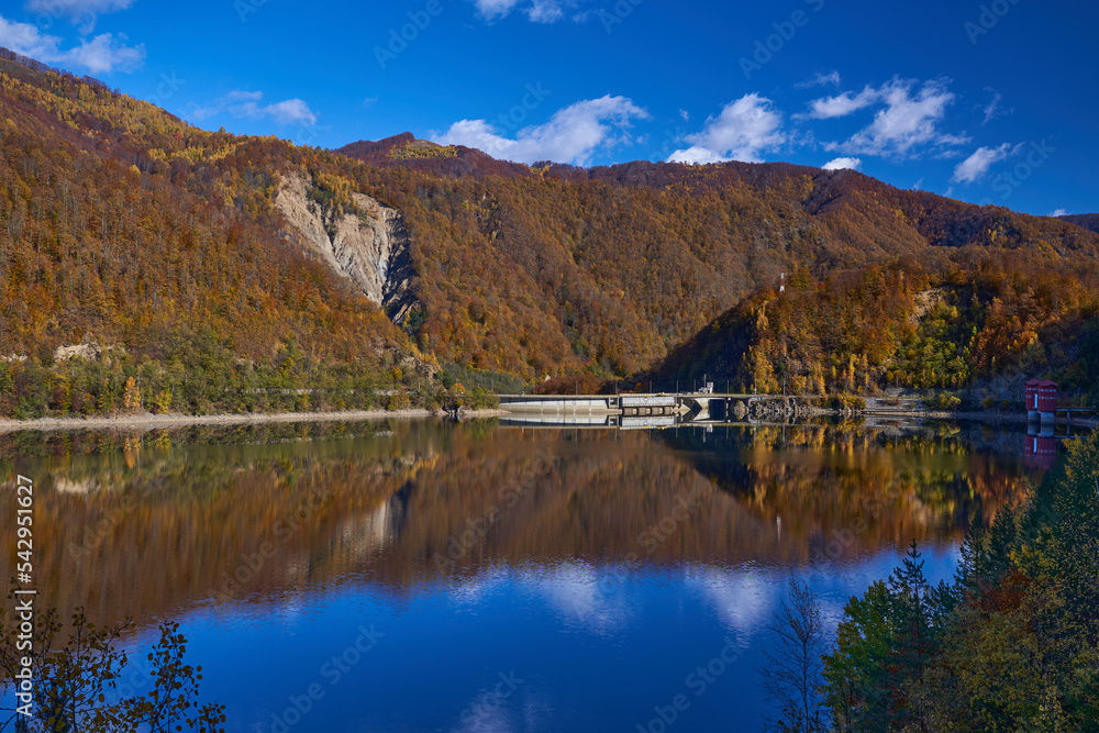 Dam lake and colorful forests in the autumn